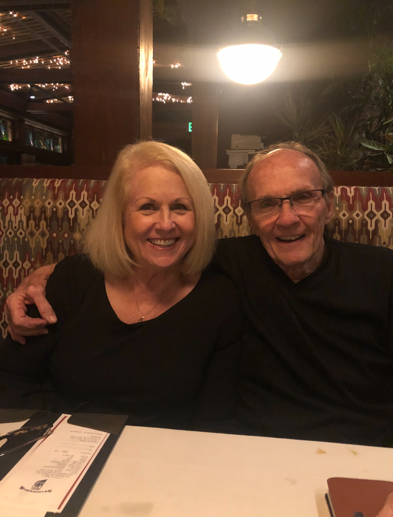 Couple smiling together at a restaurant booth