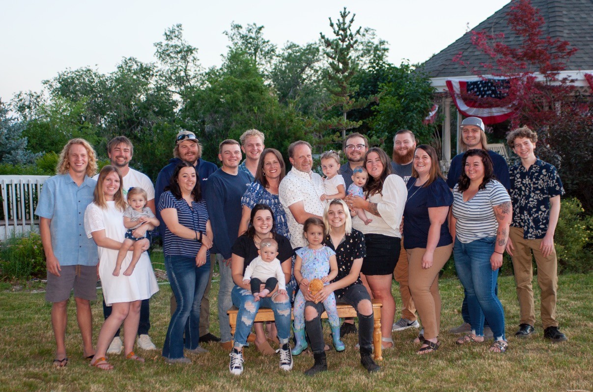 Michelle and family gathered together outdoors on a summer evening with American flag bunting