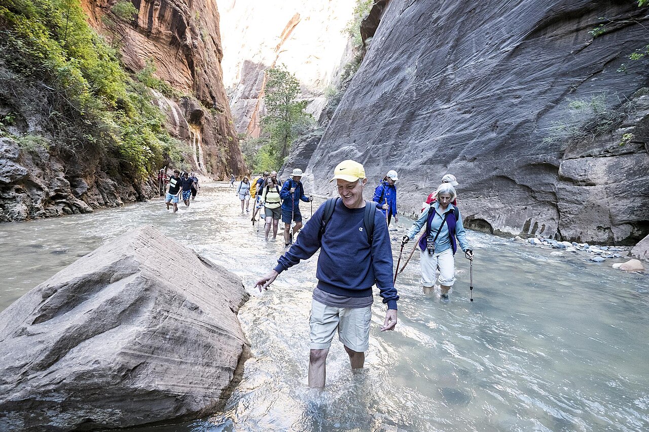 Hikers wading up the Virgin River through The Narrows in Zion National Park